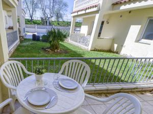 a white table and chairs on a balcony at Apartment Muga-2 by Interhome in Empuriabrava