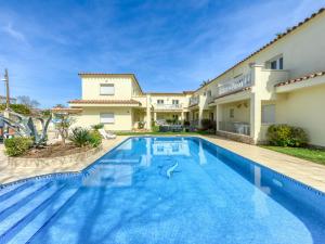 a swimming pool in front of a house at Apartment Muga-2 by Interhome in Empuriabrava