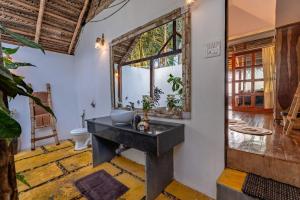 a bathroom with a sink and a mirror at The Bay Agonda in Agonda