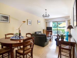 a living room with a table and chairs at Apartment Marines de Villeneuve by Interhome in Villeneuve-Loubet