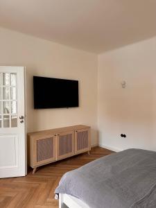 a bedroom with a flat screen tv on the wall at Apartament przy Łazienkach Królewskich in Warsaw