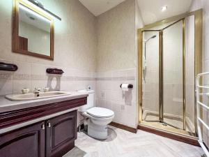 a bathroom with a toilet sink and a shower at Chalet Glen View by Interhome in Spean Bridge