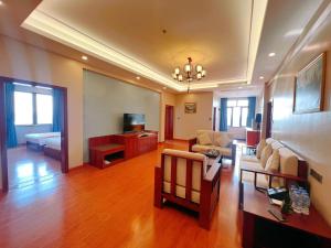 a living room with a couch and a tv at Notis International Hotel 诺蒂斯国际酒店 in Phnom Penh