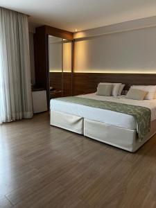 เตียงในห้องที่ Vista Azul Apart Hotel - Vista Pedra Azul