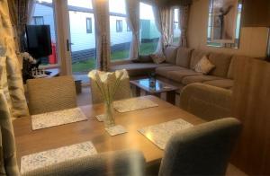 a living room with a table and a couch at Rivington Retreat in Heysham
