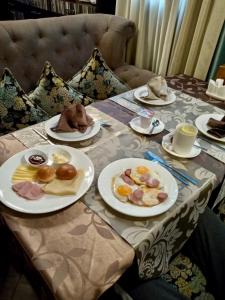 a table with plates of food on top of it at Tarlan Hotel in Aktau