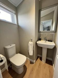 a bathroom with a toilet and a sink at Waterside Retreat Heron Lakes Nr Beverley in Beverley