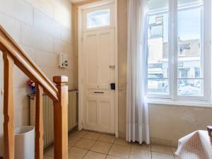 a hallway with a white door and a window at Holiday Home Gambetta by Interhome in Deauville