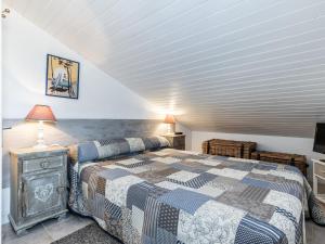a bedroom with a king sized bed and a tv at Apartment Hameau de Talaris-17 by Interhome in Les Mathes