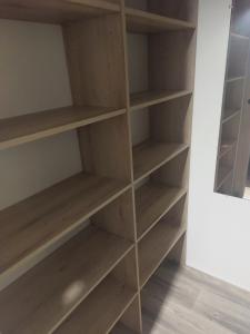 a book shelf in a room with wooden shelves at mobil home jordy a gastes 714 in Gastes