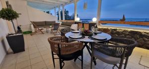 a table and chairs in a room with a view of the ocean at Gabriel House in Monolithos