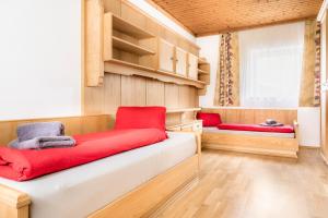 Pokój z 2 łóżkami z czerwonymi poduszkami w obiekcie Chalet Matzhof w mieście Leogang