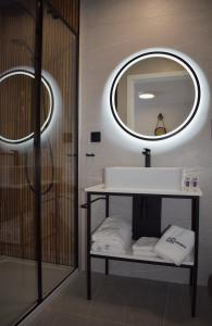 a bathroom with a sink and a mirror at Apartos Seaside Garden Luxury Apartments in Świnoujście