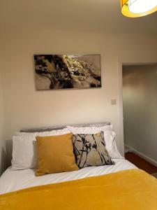 a bedroom with a bed with a painting on the wall at Impeccable 4-Bed House in Stockton-on-Tees in Stockton-on-Tees