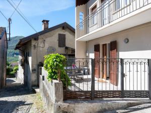 a house with a balcony and a table on a street at Holiday Home Trekking House by Interhome in Mergozzo