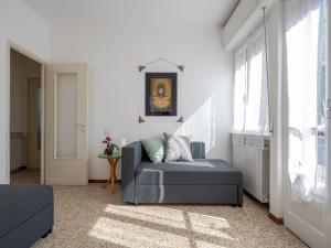 a living room with a couch and a window at Holiday Home Trekking House by Interhome in Mergozzo