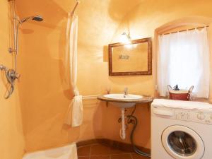 a bathroom with a sink and a washing machine at Holiday Home Casa Pinela Maria Sole by Interhome in Castellaro