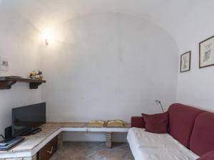 a living room with a couch and a tv at Holiday Home Casa Pinela Maria Sole by Interhome in Castellaro