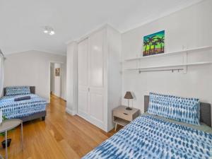 a bedroom with two beds and a table in it at 4 bdrms house ICC & Darling Harbour & central & CBD & China Town in Sydney
