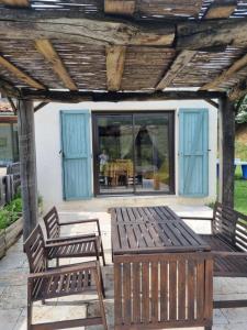 two benches and a table on a patio at Studio au cœur du Verdon in La Palud sur Verdon +1 photo