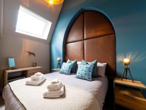 a bedroom with a large bed with towels on it at Holiday Home Towan by Interhome in Newquay +39 photos