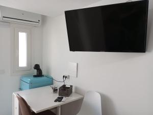 a room with a table and a television on the wall at Gaviotas Beach Golf Love 11 in Almerimar