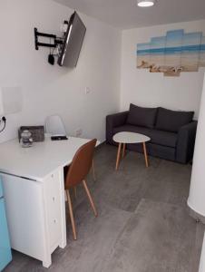 a living room with a couch and a table at Gaviotas Beach Golf Love 11 in Almerimar
