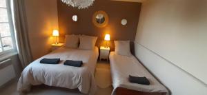 Кровать или кровати в номере Les Lucioles, Trouville- sur-Mer