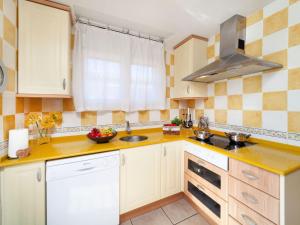 a kitchen with white cabinets and a sink at Villa Villa Capri by Interhome in Miami Platja