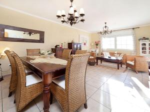 a dining room and living room with a table and chairs at Villa Villa Capri by Interhome in Miami Platja +18 photos