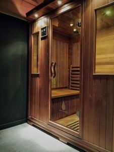 a wooden cabinet in a room with at LE COCON l'unique expérience Cinéma room de la Grange Savoyarde 1km du Lac d'Annecy in Lathuile