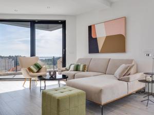 a living room with a couch and a table and chairs at Apartment Minimalist by Interhome in Šibenik