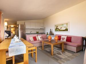 a living room with a couch and a table at Apartment 0-1-M - Marineledda by Interhome in Golfo Aranci +43 photos