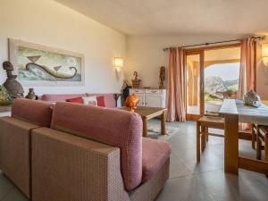 a living room with a couch and a table at Apartment 0-1-M - Marineledda by Interhome in Golfo Aranci