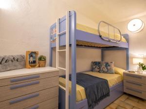 a bedroom with a bunk bed and a desk at Apartment 0-1-M - Marineledda by Interhome in Golfo Aranci