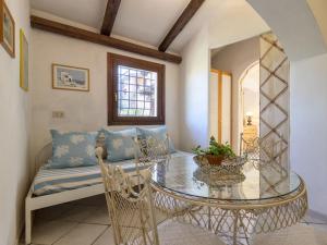 a dining room with a table and a couch at Holiday Home Damà by Interhome in Cannigione