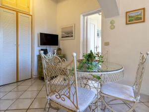 a dining room with a glass table and chairs at Holiday Home Damà by Interhome in Cannigione +34 photos