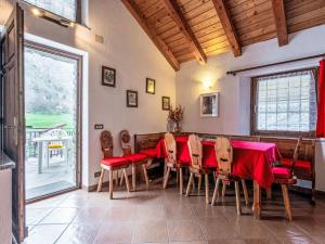 une salle à manger avec une table et des chaises rouges dans l'établissement Holiday Home Maison Le Clapey by Interhome, à Ollomont