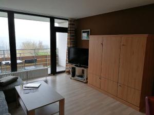 a living room with a flat screen tv and a large window at Ferienwohnung Geyersberg in Freyung