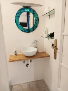 a bathroom with a sink and a mirror on the wall at Valerio's Flat in Pozzuoli