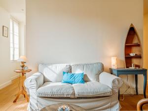een woonkamer met een witte bank en een blauw kussen bij Apartment Stella Maris by Interhome in Dinard