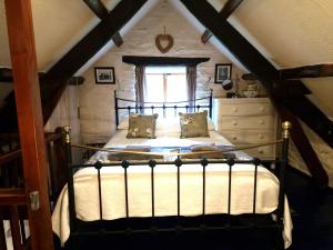 a bedroom with a bed in a attic at Y Cartws near Llangrannog in Llangrannog
