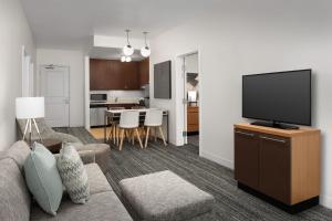 a living room with a couch and a flat screen tv at TownePlace Suites by Marriott Cheyenne Southwest/Downtown Area in Cheyenne
