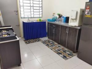 a kitchen with a sink and a stove in it at SAFI Homestay Perlis in Arau +10 photos