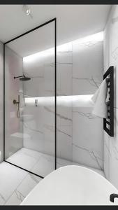 a shower with a glass door in a bathroom at First Class Airport Hotel's With Free Transportation in Arnavutköy