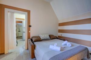 a bedroom with a bed with towels on it at Appartamento Gabriella - Happy Rentals in Laveno-Mombello