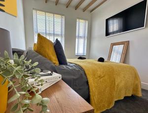 a living room with a couch and a tv at Breakers Guest House in Newquay
