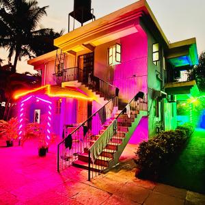 a house with pink and green lights on it at The Grey Villa - Private Pool in Calangute
