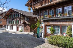 a wooden house with a fire hydrant in front of it at Apartment am schönen Brienzersee in Brienz