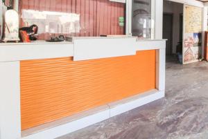 an orange and white counter in a store at Goroomgo Viren Pacific Agra Near Taj Mahal - Wonderfull Stay with Family in Agra